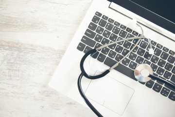 stethoscope on the white computer keyboard on desk