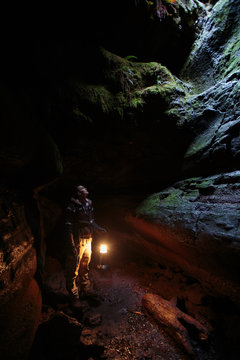 A male caver looks up into a natural opening in the upper section of the 13,042 foot long Ape Cave near Mount St. Helens in the Gifford Pinchot National Forest of western Washington State. The cave is the third longest known lava tube in North America. The cave is open year round and has a easier, shorter lower cave section and a slightly more physical and longer upper cave section.