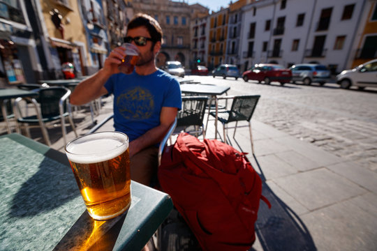 A man has a beer in the main square in the old town section of Cuenca, Spain, a UNESCO World Heritage Site..