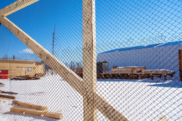 blue sky through a metal grid. fence fence.