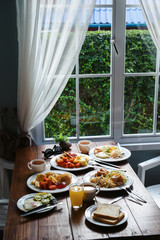 Country side breakfast composition for family in the morning. Window at the background
