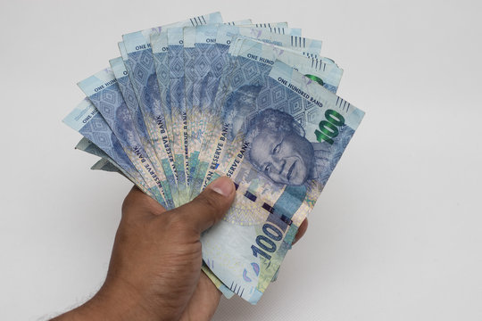 Hand holding south african rands