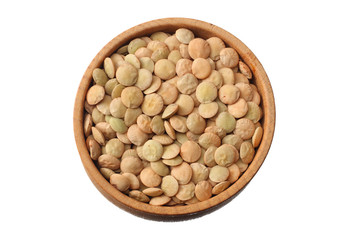 Pile lentil in wooden bowl isolated on white background. Top view.