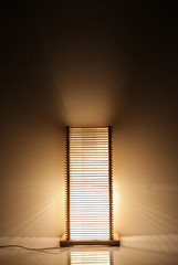 Handmade wooden lamp on brown background