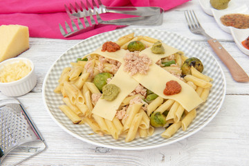 Pasta de macarrones con salsa roja, amarilla y verde.