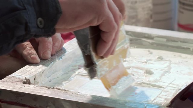 Close-up Of The Hand Of A Typography Worker Paint