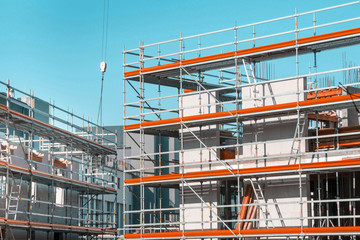 building under construction - construction site with scaffolding at the facade - obrazy, fototapety, plakaty