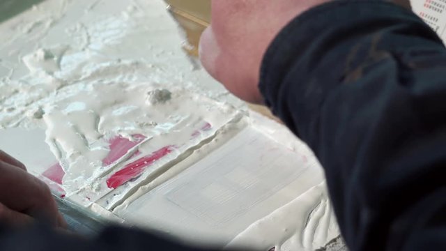 Close-up Of The Hand Of A Typography Worker Paint