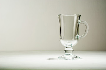 Glass empty glass or cup for mulled wine. Light background. Plenty of room for text.