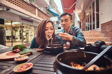 Asian couple are eating at chinese cafe