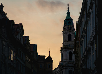 Naklejka premium St. Nicholas Church in Prague during sunset in Spring 2019 - Showing the fine detail of the clock and decoration