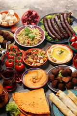 Middle eastern or arabic dishes and assorted meze, concrete rustic background. Falafel. Turkish...