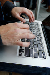 Fototapeta na wymiar Male hands working on a computer keyboard. Print text message