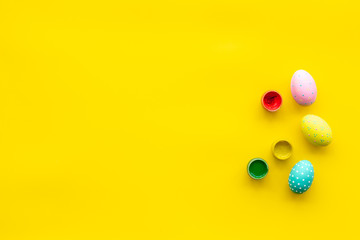 paint eggs for Easter celebration on yellow background top view mock up