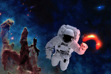 Fototapeta na wymiar Space astronaut near black hole glow near pillars of creation. Space adventure in outer space. Science fiction. Elements of this image were furnished by NASA