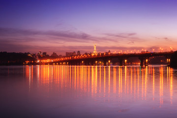 Panoramic view of the Paton bridge, Motherland monument and Dnieper river at night, beautiful cityscape with city lights, Kiev the capital of Ukraine