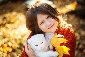 girl with flowing hair with a white cat, autumn