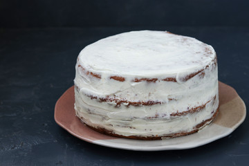 Preparing a biscuit cake for decorating cream on a dark background