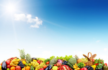 Obraz na płótnie Canvas Variety vegetables and fruits against sky