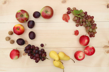 Naklejka na ściany i meble ripe fruits and berries on wooden background