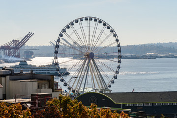 A ferry and waterwheel next to Elliott Bay in Seattle