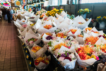 Bouquets of varied flowers in a stand at the Pike Place Market in Seattle