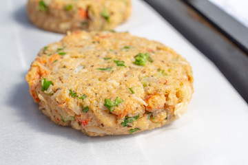 Best fish cakes raw uncooked on  baking tray. . Close up of crab patties.