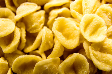 Close-up of Orecchiette, wheat semolina pasta made one by one by hand in a traditional way in the Italian region of Bari.