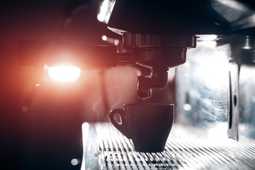 silhouette of coffee making process; espresso cup and coffee machine;
