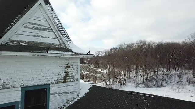AERIAL: close pass through the tower section of The Mineola Hotel in Fox Lake, Illinois.