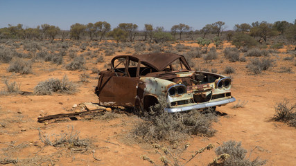 Rusty wreck of crashed car in the middle of desert (warning to inattentive drivers), Stuart Highway, Australia