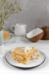 Morning, breakfast - traditional russian blini pancakes, french crepes, fresh coconut, milk bottle, white ceramic pitcher