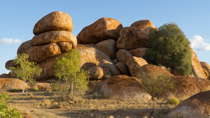 Fototapeta na wymiar Devils Marbles - magical red boulders in Red Center during late afternoon, Australia