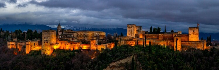 Fototapeta na wymiar Panoramic Night view at Alhambra palace and fortress complex. Arabic fortress of Alhambra, Granada, Spain