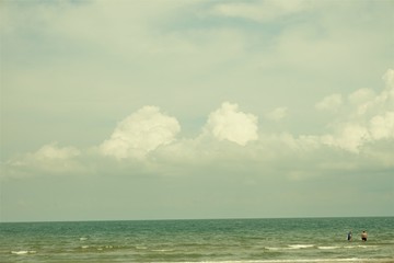 Fototapeta na wymiar View of sea and sandy beach with sky and cloudscape at Takiab beach, Huahin Thailand.