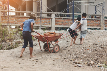 Children working at construction site for world day against child labour concept: