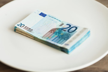 Money lying on the plate. Euros photo. Greedy corruption concept. Bribe idea.