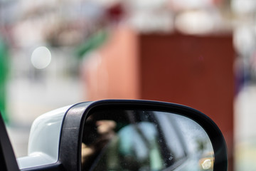 Naklejka premium a blurry closeup shoot to car side mirror while moving