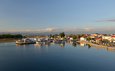 Fototapeta na wymiar Keramoti, Greece port with boats, promenade view, tavernas, cafe and restaurants