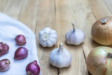 Top view of herbal vegetable ingredients, fresh garlic and red onion, on old wooden table, cooking preparation concept