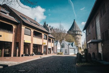 Obraz premium European narrow streets with medieval castle on background