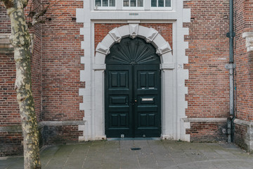 Fototapeta na wymiar Arch entry door on red brick wall background