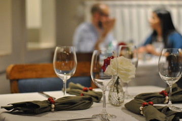 Glasses in romantic dinner with couple