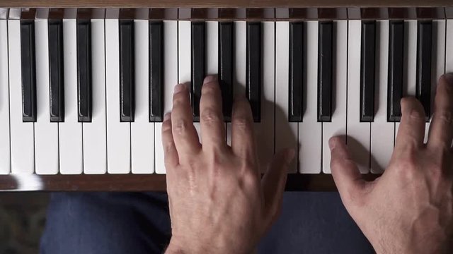 Musician plays piano, Slow Motion Top View Medium shot with shallow depth of field