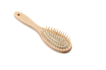 Wooden hair brush on white background. Studio shot.