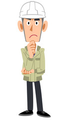 ヘルメットを装着して考える工務店の男性