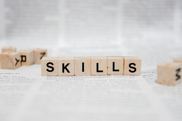 Skills Word Written In Wooden Cube - Newspaper