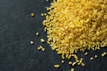 Bulgur groats on a dark background