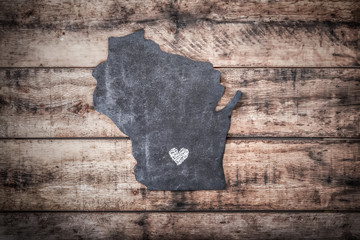 Blackboard shaped like the state of wisconsin with a heart drawn in chalk for the capital