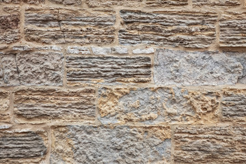 Old crumbling limestone slab wall